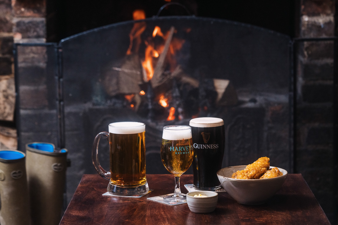 three beers and some food by fire