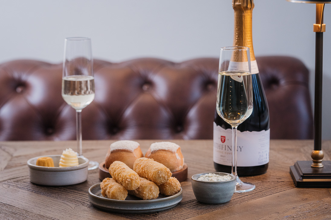 Sparkling wine and small plates, Cauliflower Cheese Croquets and Bread rolls with butter